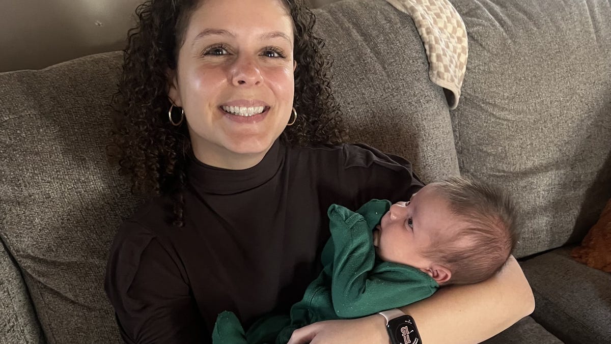 Women and the Caregiving Economy Reporter Madeline Mitchell holding her childhood friend Ariana Georganas' son, Callahan.