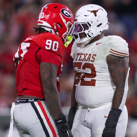Nov 15, 2025; Athens, Georgia, USA; Georgia Bulldogs defensive lineman Elijah Griffin (90) and Texas Longhorns offensive lineman DJ Campbell (52) interact in the second half at Sanford Stadium. Mandatory Credit: Brett Davis-Imagn Images