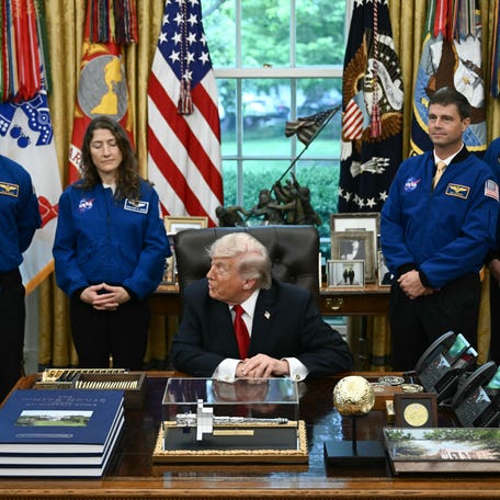 US President Donald Trump welcomes Artemis II astronauts Victor Glover (L), Christina Koch (2nd L), Reid Wiseman (2nd R) and Jeremy Hansen (R) in the Oval Office at the White House in Washington, DC, on April 29, 2026.