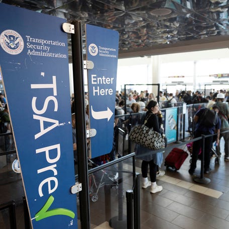 Passengers line up at a Transportation Security Administration (TSA) checkpoint at Luis Munoz Marin International Airport in Carolina, Puerto Rico, March 27, 2026.