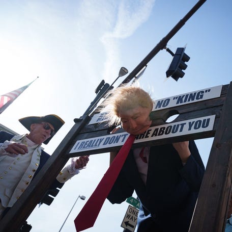 Protesters pillory a mannequin dressed as President Donald Trump as they march for "No Kings Day" on March 28, 2026, in Phoenix.