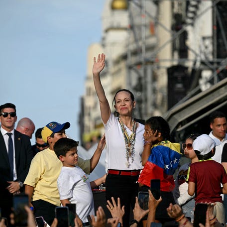 Venezuelan opposition leader Maria Corina Machado gestures on stage in front of supporters in Madrid's Puerta del Sol on April 18, 2026.