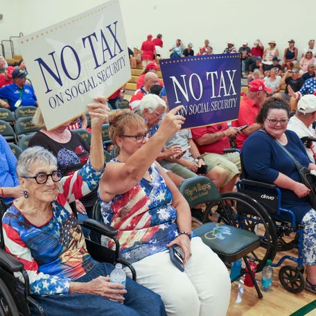 Supporters hold signs before President Donald Trump speaks at Middleton High School (The Villages Charter School) on May 1, 2026, in The Villages.