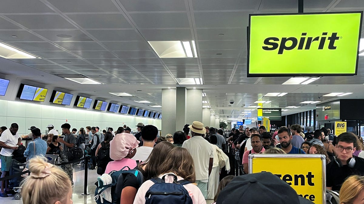 Travelers stand in line at the check-in counter at Spirit Airlines at Newark Liberty International Airport, in Newark, New Jersey, U.S., June 30, 2025.