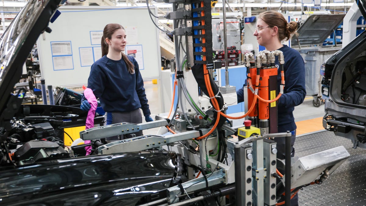 Volkswagen assembly workers Nadja Saueressig, left, and Jasmin Artmann, right, working at the front of an ID line electric car at the Volkswagen electric car factory on February 24, 2026 in Emden, Germany. Volkswagen rose in 2025 to first place in electric car sales in Europe, beating out rival Tesla.