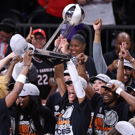 A'ja Wilson (22) of the Las Vegas Aces holds up the championship trophy after winning Game 4 of the 2025 WNBA Finals at Mortgage Matchup Center on Oct. 10, 2025.