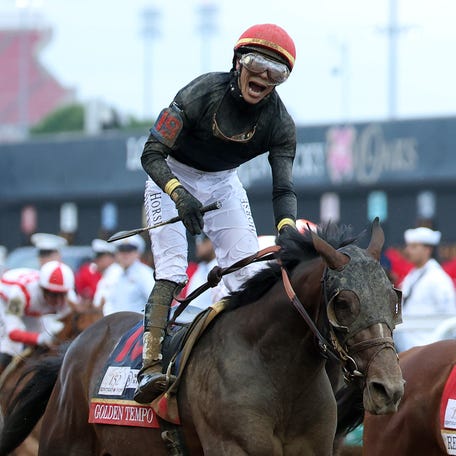 Golden Tempo, ridden by jockey Jose Ortiz, crosses the finish line to win the 152nd running of the Kentucky Derby at Churchill Downs.