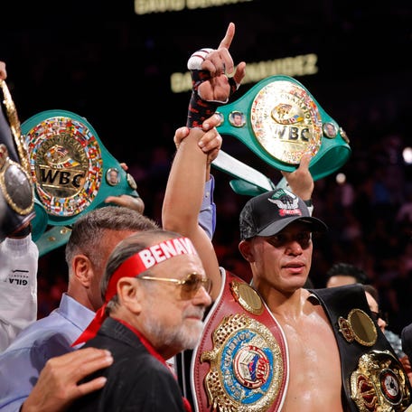 David Benavidez (C) poses with the title belts after defeating WBA/WBO cruiserweight champion Gilberto Ramirez at T-Mobile Arena on May 2.