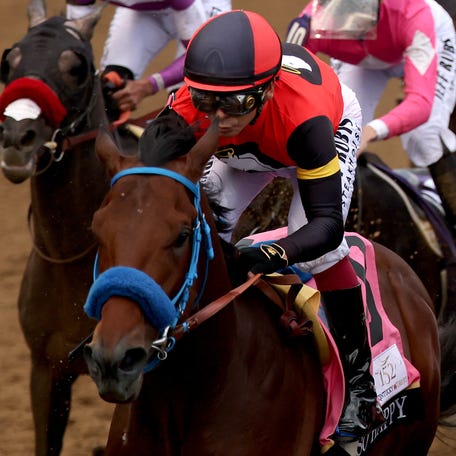 So Happy (front left), ridden by jockey Mike Smith, and Danon Bourbon (front right), ridden by jockey Atsuya Nishimura, lead the field during the 152nd running of the Kentucky Derby at Churchill Downs.