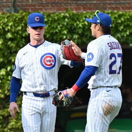May 3, 2026; Chicago, Illinois, USA; Chicago Cubs left fielder Ian Happ (8), center fielder Pete Crow-Armstrong (4) and right fielder Seiya Suzuki (27) celebrate their victory over the Arizona Diamondbacks at Wrigley Field. Mandatory Credit: Patrick Gorski-Imagn Images