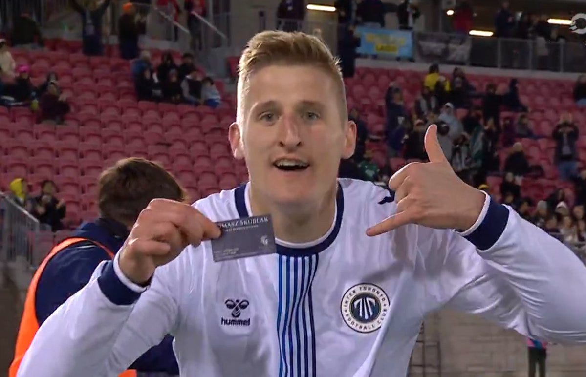 Canadian forward/real estate agent flashes business card in goal celebration