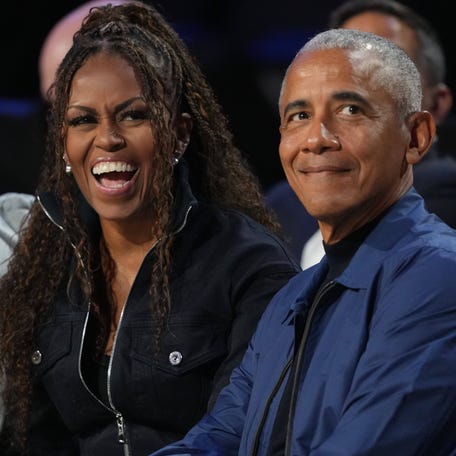 Former first lady Michelle Obama and former President Barack Obama look on before the start of the 75th NBA All Star Game at Intuit Dome in Inglewood, California.