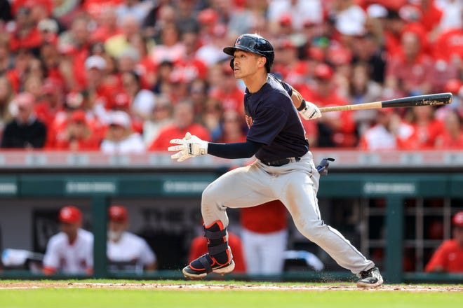 FILE - Cleveland Guardians' Steven Kwan hits an RBI-sacrifice fly during a baseball game against the Cincinnati Reds in Cincinnati, Tuesday, April 12, 2022. Kwan was a rookie surprise for the Cleveland Guardians in 2022. He batted .298 with 52 RBIs while helping the team win the AL Central title. (AP Photo/Aaron Doster, File)