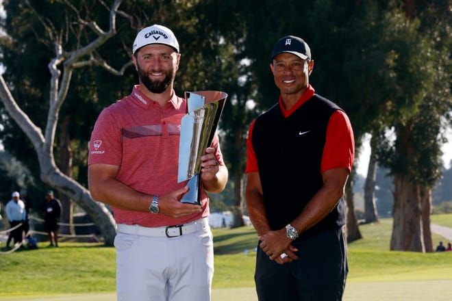 Jon Rahm holds the winner's trophy for the Genesis Invitational, after it was presented to him by host Tiger Woods. Under changes made by the PGA Tour Policy Board, events such as the Genesis and this week's Arnold Palmer Invitational will have reduced fields and no 36-hole cut.