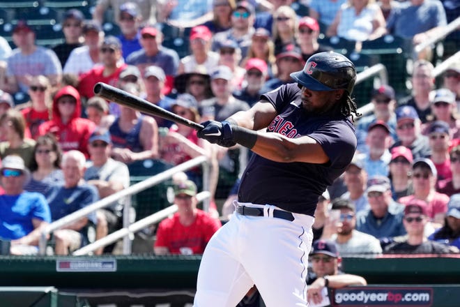 Cleveland Guardians' Josh Bell connects for a run-scoring single against the Los Angeles Angels during the first inning of a spring training baseball game Tuesday, March 14, 2023, in Goodyear, Ariz. (AP Photo/Ross D. Franklin)