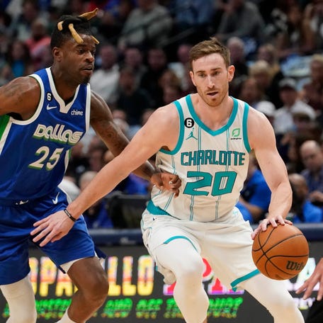 Charlotte Hornets forward Gordon Hayward (20) drives against Dallas Mavericks defenders Reggie Bullock (25) and Dwight Powell (7) during the first quarter of an NBA basketball game in Dallas, Friday, March 24, 2023. (AP Photo/LM Otero)