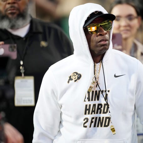 Colorado head coach Deion Sanders walks the perimeter of the field as players warm up before an NCAA college football game against Colorado State, Saturday, Sept. 16, 2023, in Boulder, Colo. (AP Photo/David Zalubowski)