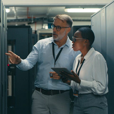 Two technicians discussing something in a data cen