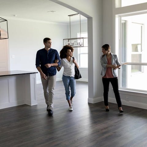 Two people viewing the interior of a house with a 