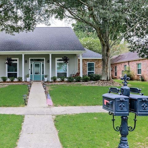 A house with a large front lawn.