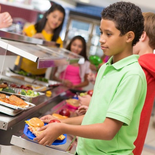 Kids in school cafeteria lunch line.