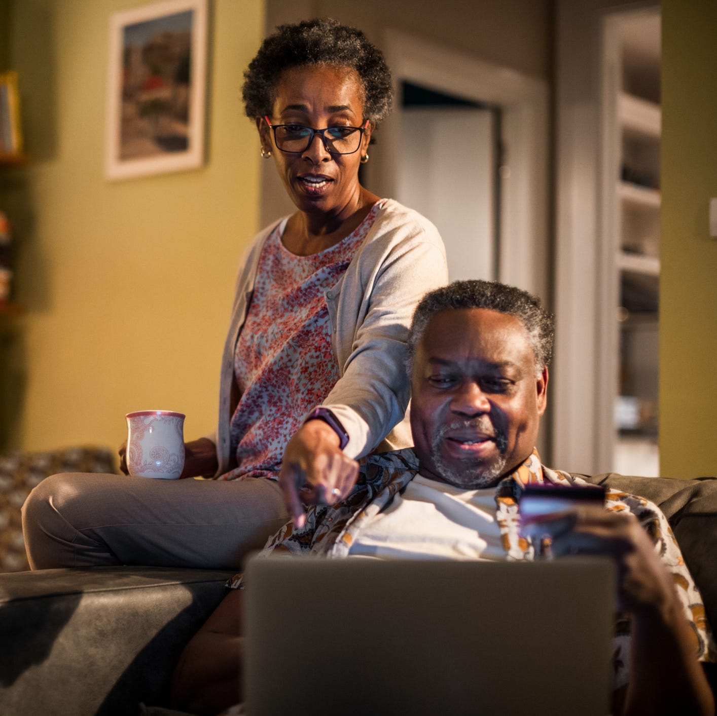 Two adults looking at financial paperwork.