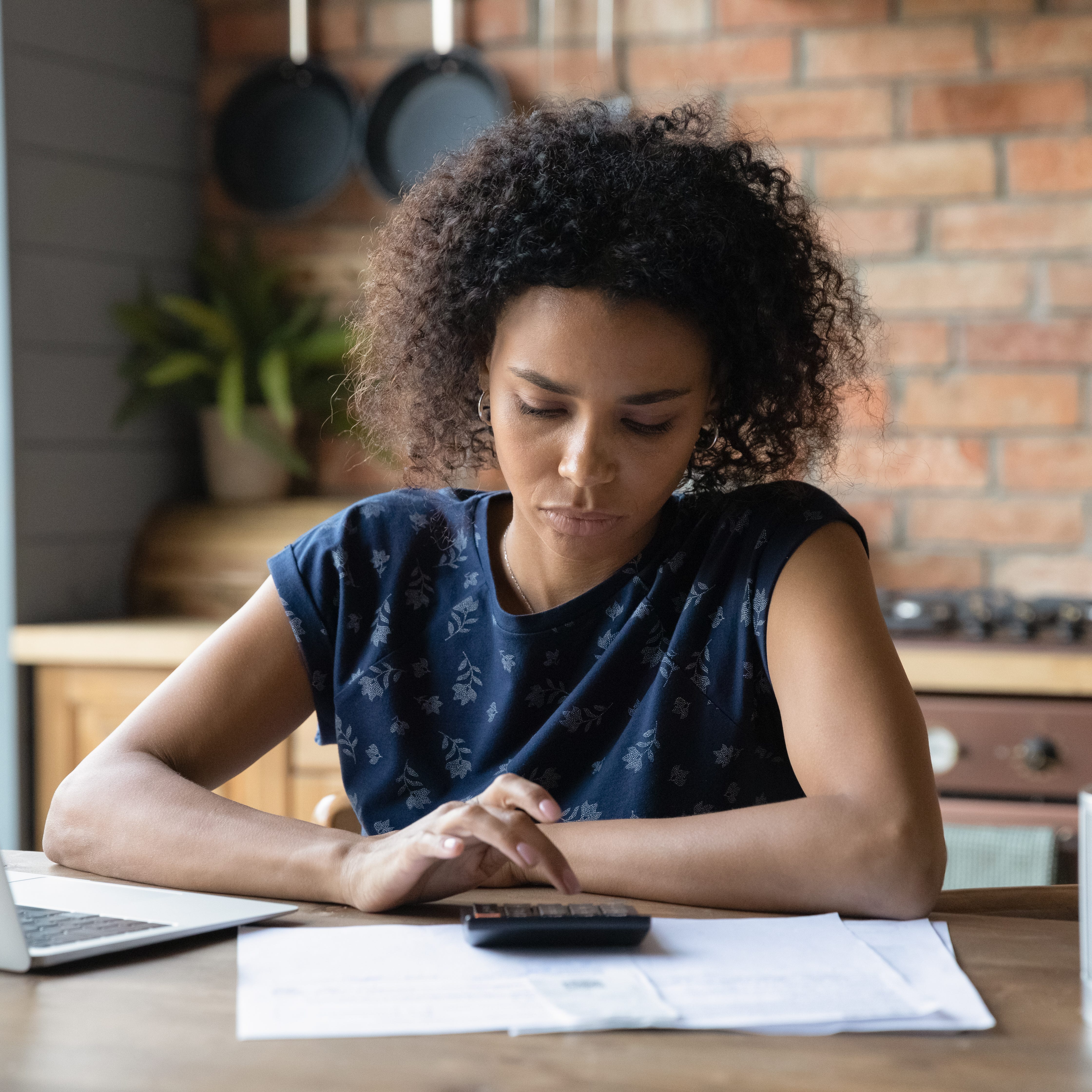 Adult looking at financial paperwork.