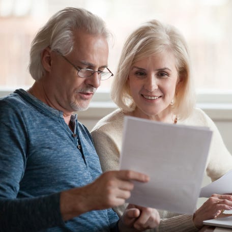 Two people look at paperwork.