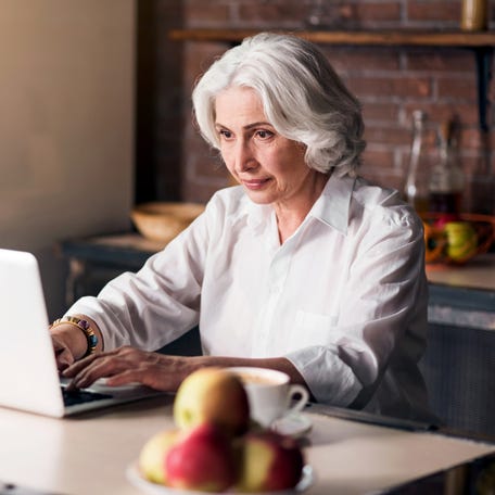 Woman working on a laptop.