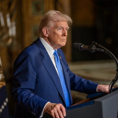 President Trump is shown at a podium.