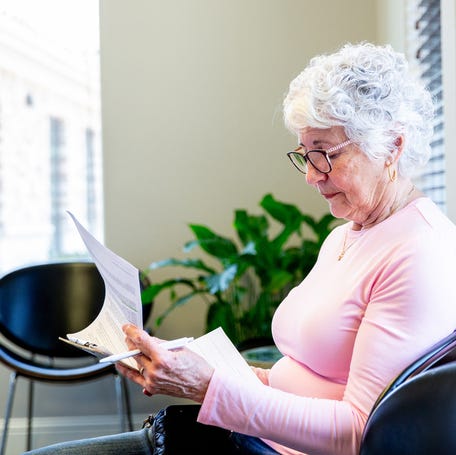 Person reading medical paperwork.