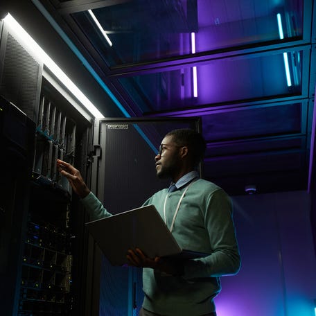 Person looking at a GPU in a data center.