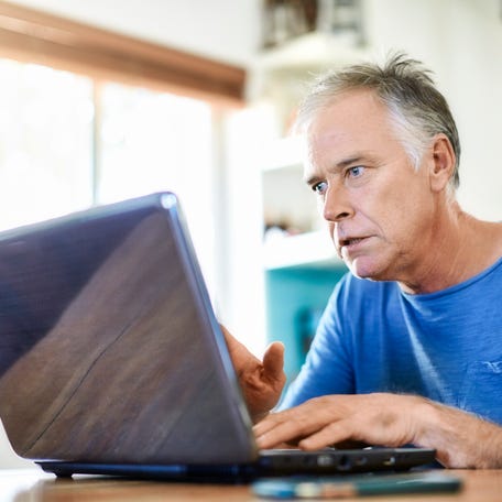 A person looking at a laptop.