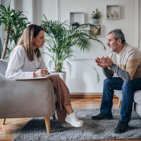 A person talking to a therapist.