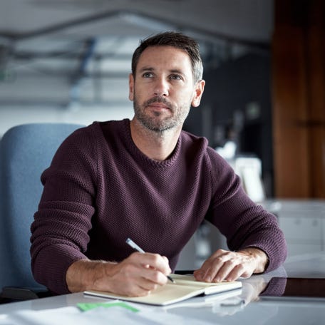 A person writing in a notebook.