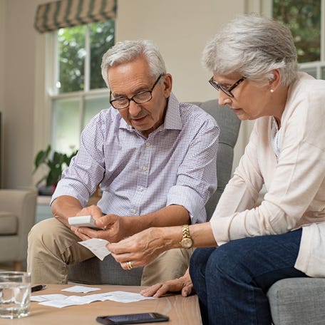 Adults looking at financial paperwork.