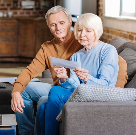 Couple looking at check together.