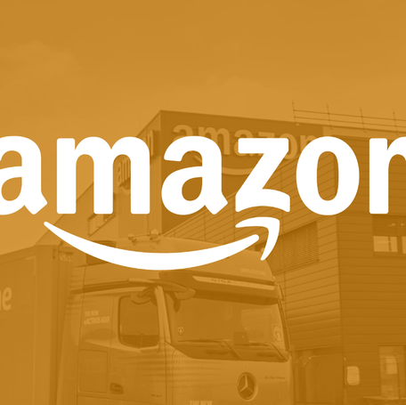 Amazon name on yellow screen filter with warehouse and truck in background.