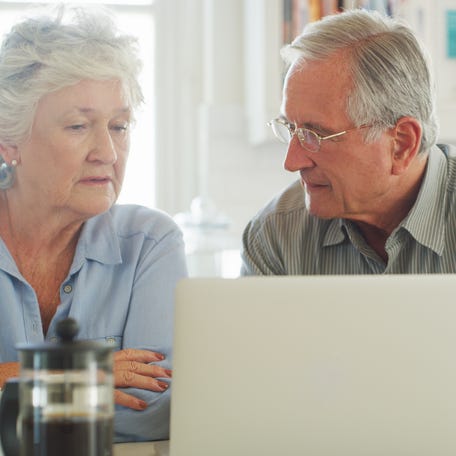 Two people at a laptop.