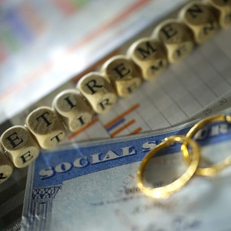 Wedding rings on top of a Social Security card.