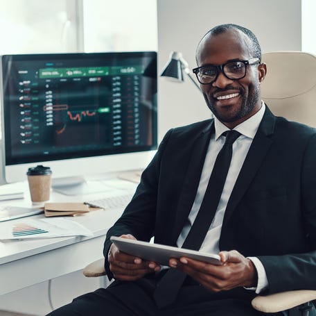 Businessman with a stock chart in the background.