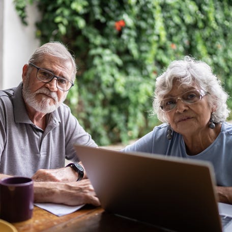 Two people at a laptop.