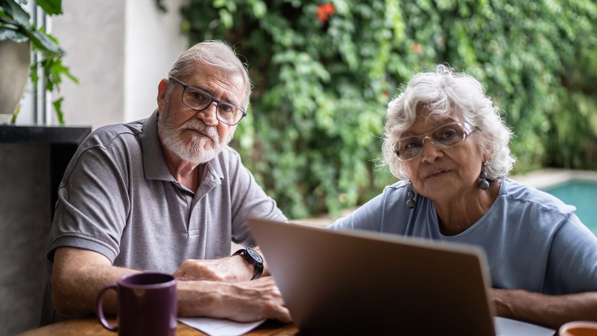 Two people at a laptop.