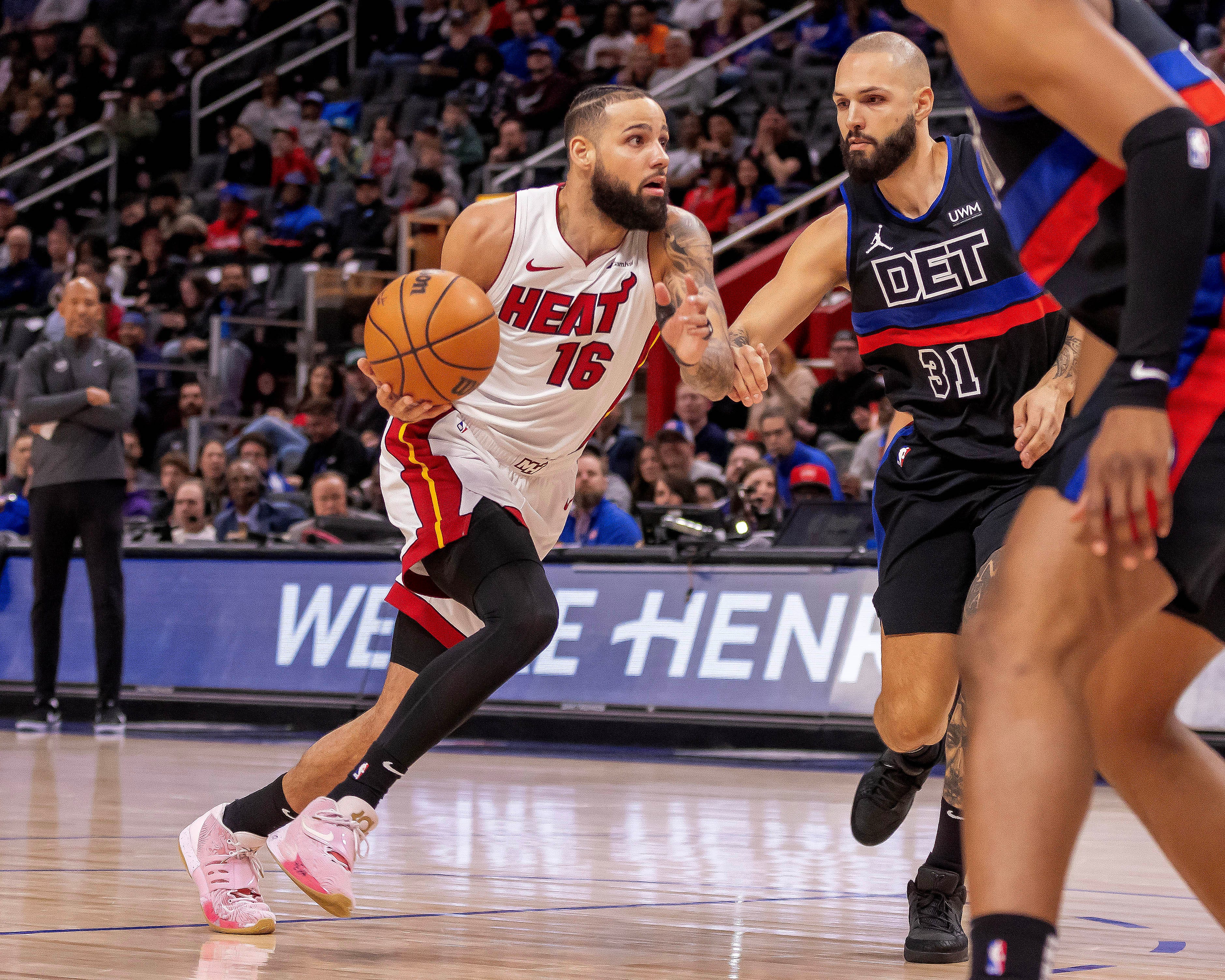 Mar 15, 2024; Detroit, Michigan, USA; Miami Heat forward Caleb Martin (16) drives to the basket as Detroit Pistons guard Evan Fournier (31) defends during the first quarter at Little Caesars Arena. Mandatory Credit: David Reginek-USA TODAY Sports