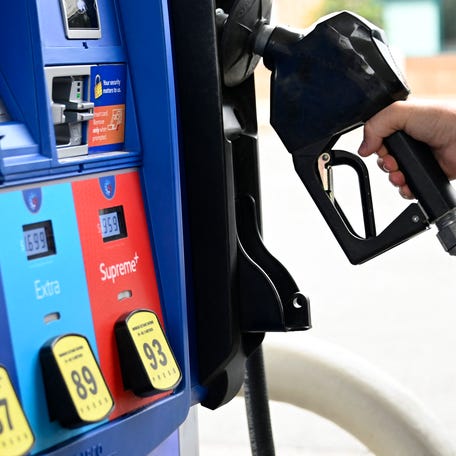 A person goes to the pump at a gas station on July 29, 2022 in Arlington, Virginia. - The US economy contracted for a second straight quarter between April and June, government data showed Thursday, adding fuel to recession fears in a headache for President Joe Biden ahead of midterm elections. (Photo by OLIVIER DOULIERY / AFP) (Photo by OLIVIER DOULIERY/AFP via Getty Images)