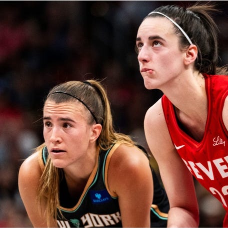 Jul 6, 2024; Indianapolis, Indiana, USA; New York Liberty guard Sabrina Ionescu (20) and Indiana Fever guard Caitlin Clark (22) watch a free throw at Gainbridge Fieldhouse. Mandatory Credit: Grace Smith/INDIANAPOLIS STAR-USA TODAY Sports ORG XMIT: IMAGN-744967 ORIG FILE ID: 20240706_gma_usa_0289.JPG