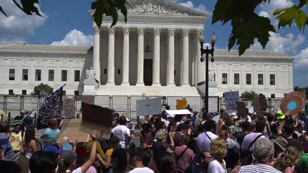 Dueling protesters outside Supreme Court building