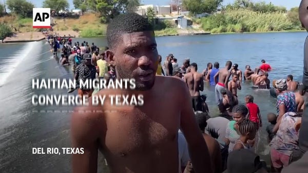 Haitian migrants converge by Texas border bridge