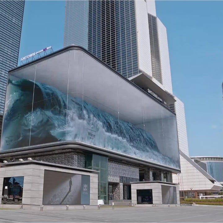 Virtual wave crashes inside glass box above pedestrians in Seoul