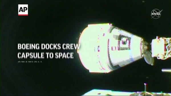 Boeing docks crew capsule to space station